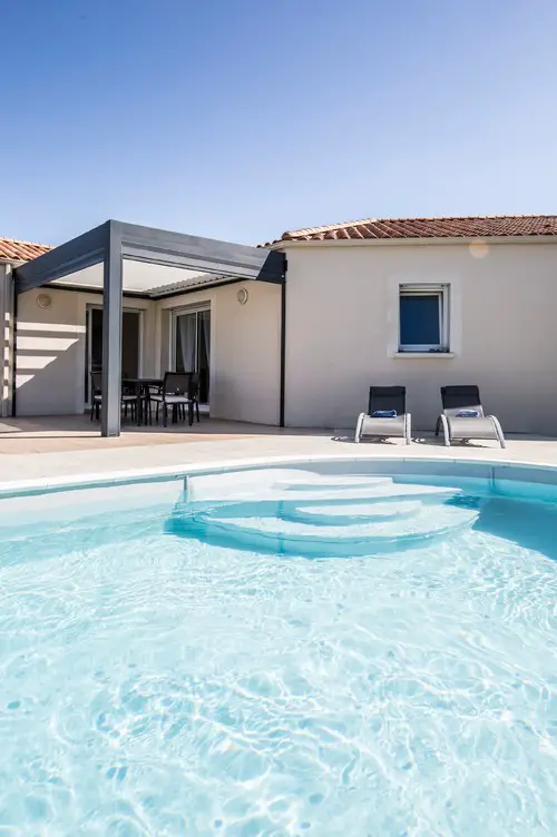 Curved White Concrete Pool and Patio