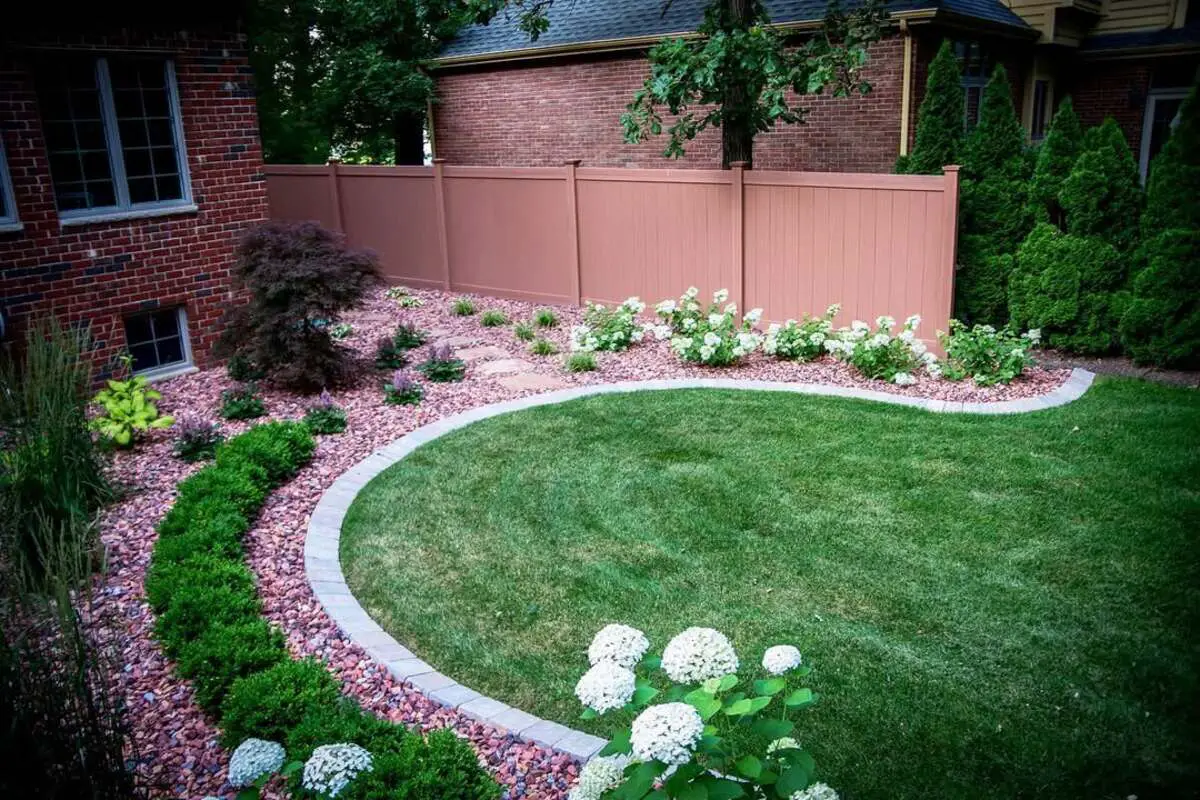 29 Brick Landscaping Ideas to Give Your Yard Timeless Charm 11 Curved Pink Gravel Bed