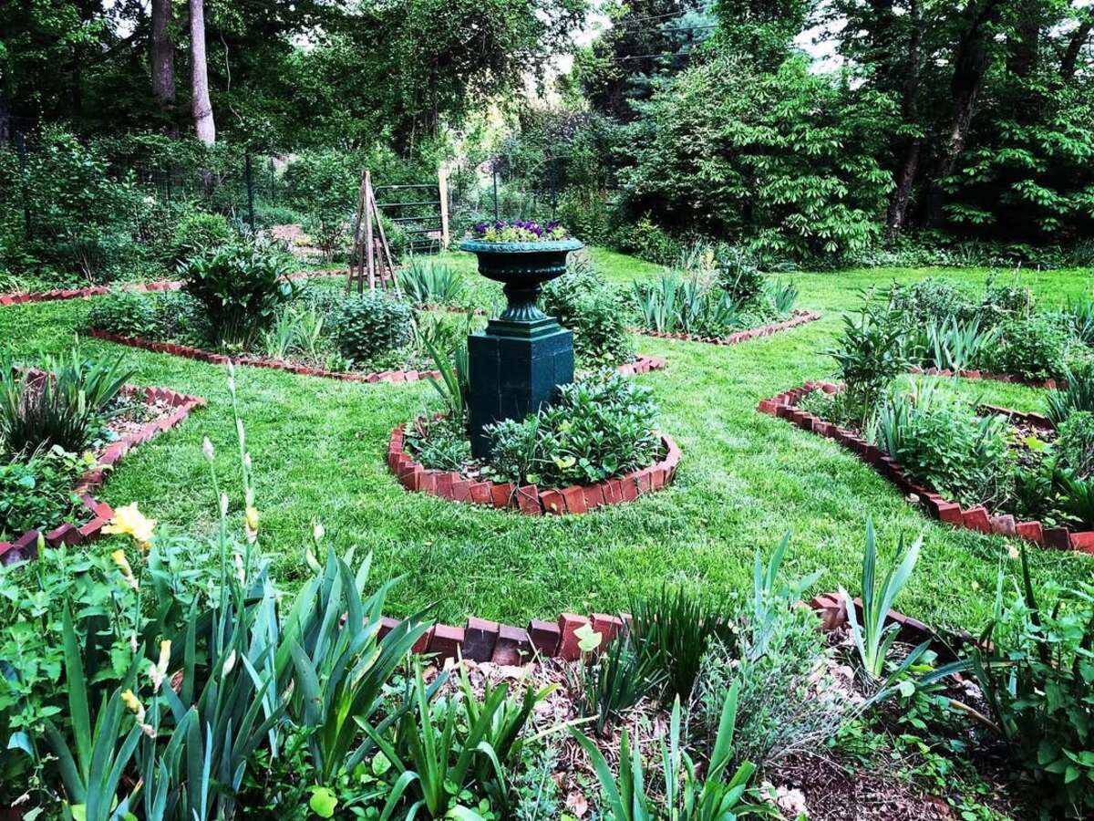 29 Brick Landscaping Ideas to Give Your Yard Timeless Charm 14 Sawtooth Brick Garden Beds