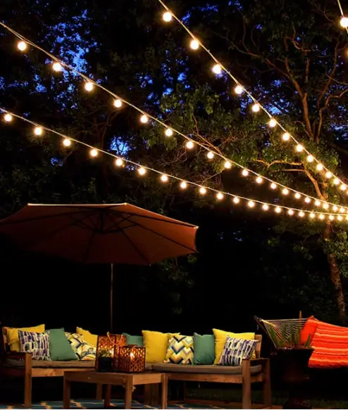 31+ Outdoor String Lighting Ideas for a Cozy and Beautiful Backyard 5 Canopy of outdoor string lights illuminating backyard seating