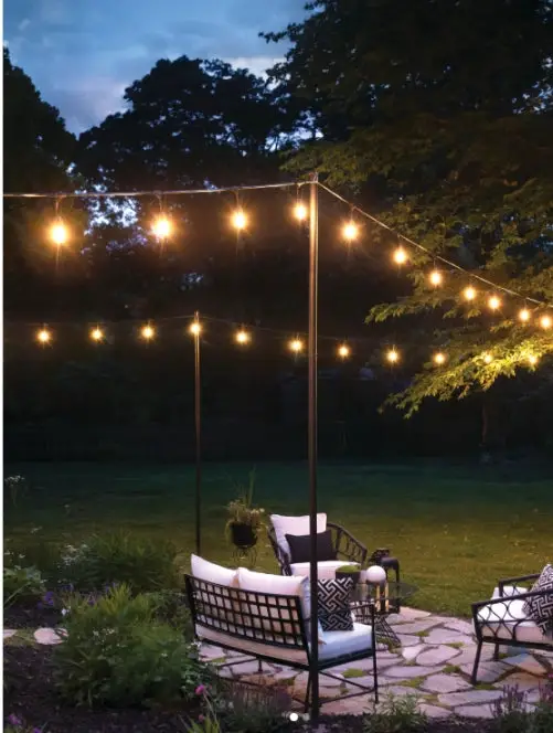 31+ Outdoor String Lighting Ideas for a Cozy and Beautiful Backyard 9 Flagstone patio on an open lawn with overhead string lights