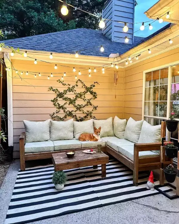 31+ Outdoor String Lighting Ideas for a Cozy and Beautiful Backyard 15 Cozy patio corner with outdoor sectional seating and overhead globe lights