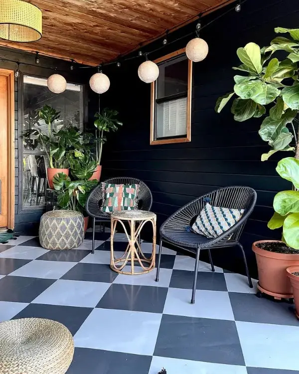 31+ Outdoor String Lighting Ideas for a Cozy and Beautiful Backyard 19 Covered porch with round paper lantern string lights and black wicker chairs