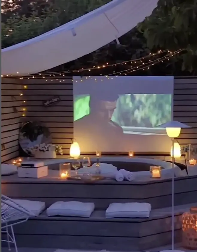 31+ Outdoor String Lighting Ideas for a Cozy and Beautiful Backyard 21 Outdoor hot tub cinema with projector screen and soft string lighting