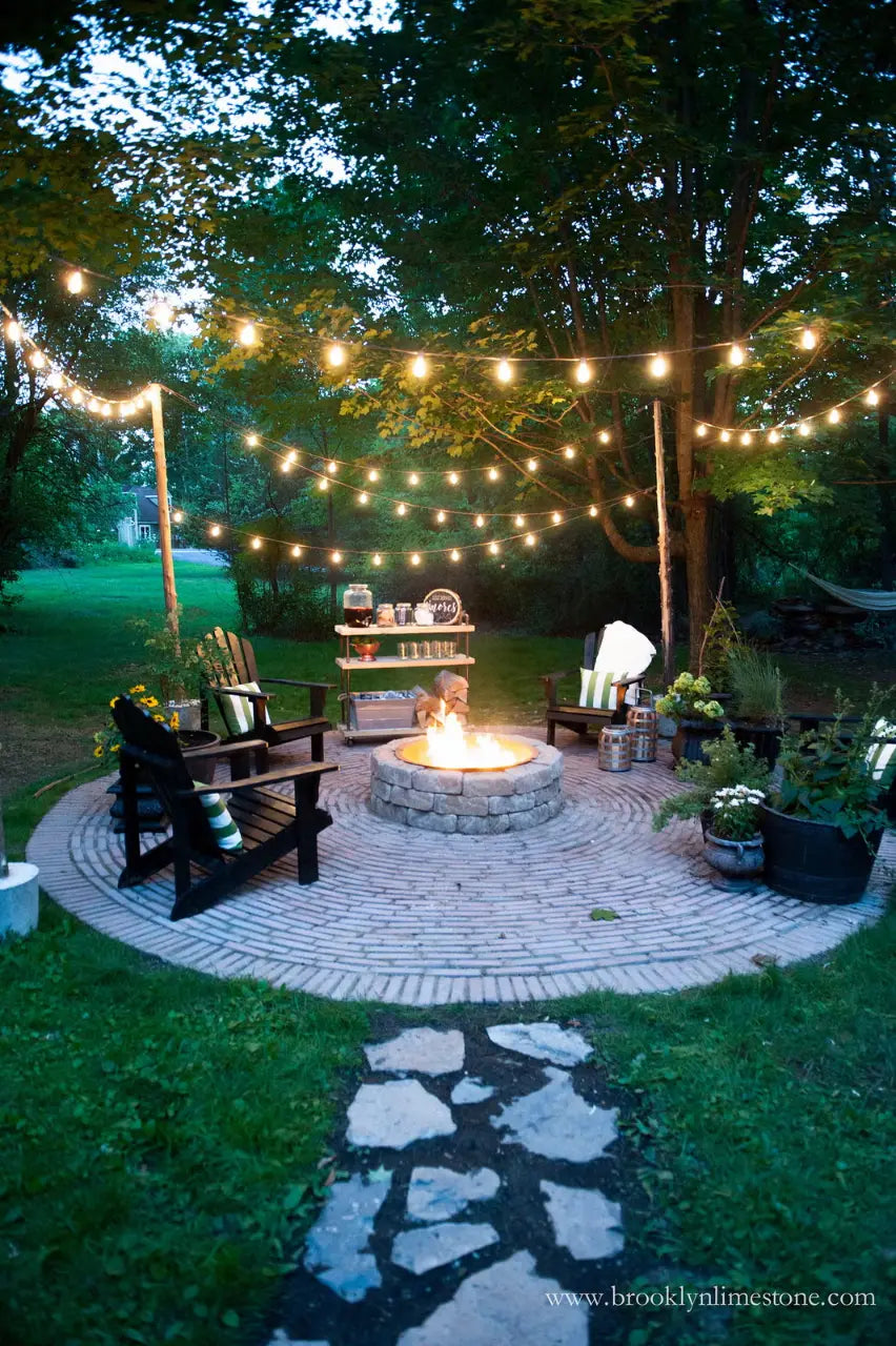 31+ Outdoor String Lighting Ideas for a Cozy and Beautiful Backyard 22 Circular brick patio with fire pit Adirondack chairs and overhead string lights