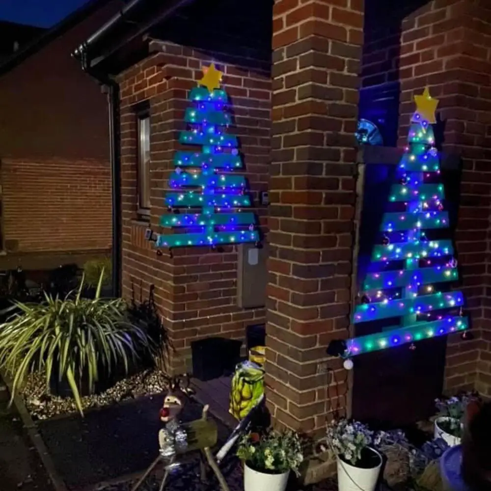 27+ Wood Christmas Trees DIY Ideas for Rustic and Creative Holiday Decor 11 Blue Lighted Brick Wall Pallet Trees