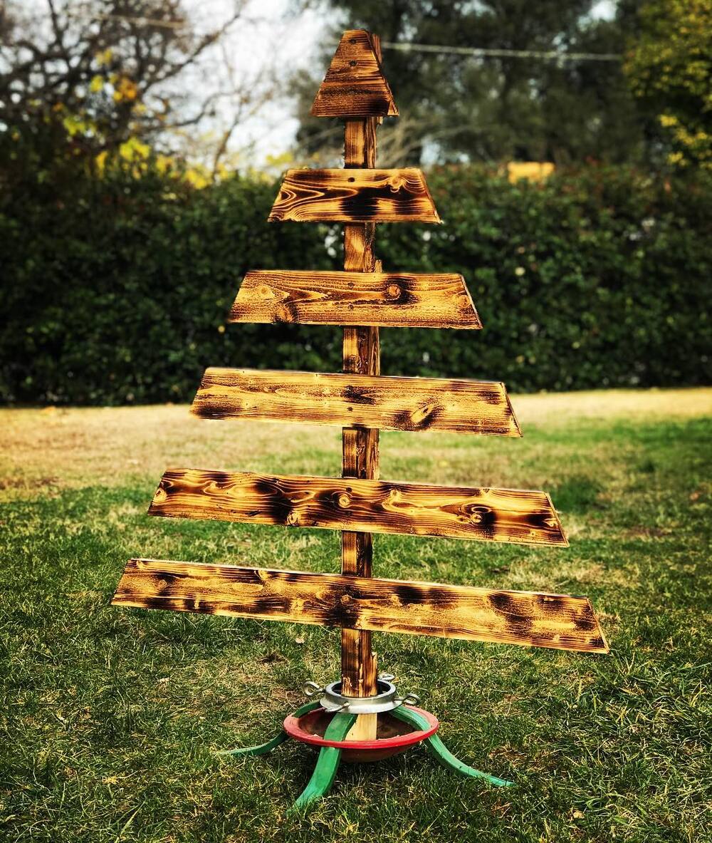 27+ Wood Christmas Trees DIY Ideas for Rustic and Creative Holiday Decor 21 Torched Wood Slat Tree in Vintage Stand